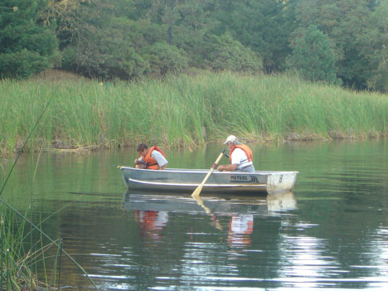 Campers in a rowboat out in the leg near the tulles.