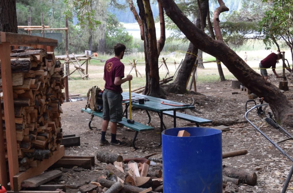 Scoutcraft staff preparing logs and kindling.