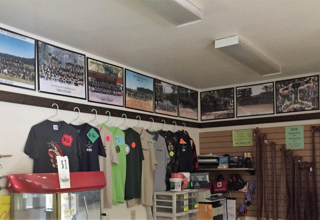 Behind the counter T-shirt & Belt displays and Staff photos line the top of the wall.